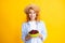 Charming woman with cherry plate isolated on yellow.