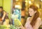 Charming woman choosing pineapple while shopping in grocery store