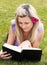 Charming woman reading a book in a park