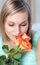 Charming woman smelling roses