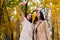 Charming women do selfie on autumn background