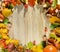 Charming wreath of colorful autumn leaves, pumpkins, rowan berries on a wooden background close-up. Place for an