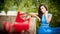 Charming young brunette woman in bright blue dress with red shoes in foreground. gorgeous fashionable woman, outdoor shot