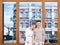 The charming young couple poses against the background of reflection of the city building