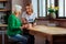 Charming young fair-haired woman discussing with short-haired pensioner Bible book