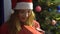 A charming young girl in Hat Santa gets Christmas gift