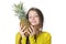 Charming young girl presses to face large ripe pineapple.