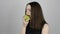 Charming young woman eats a green apple and smiles