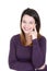 Charming young woman having shy smile posing in studio in closed posture keeping arms folded