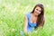 Charming young woman sitting green