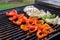 charred bell peppers and onions for fajitas on a grill