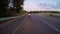 Chase view of a fast motorcycle driving on a curved road