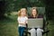 Chat online with family on laptop on picnic in nature. Homeschooling, freelance job. Mom and child. Mother work on Internet with