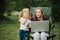 Chat online with family on laptop on picnic in nature. Homeschooling, freelance job. Mom and child. Mother work on Internet with