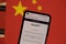 ChatGPT chat bot on smartphone screen and China flag in background. OpenAI chat bot artifical intelligence