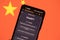 ChatGPT chat bot on smartphone screen and China flag in background. OpenAI chat bot artifical intelligence