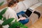 Chatty young woman watching laptop, sitting on a couch in her apartment