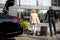 Chauffeur helps a businesswoman to carry her suitcase