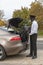 Chauffeur loading luggage into boot of a car