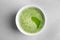 Chawan with fresh matcha tea on grey background