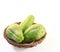 Chayote squash, also known as choko in wooden basket on white