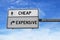 Cheap and expensive road sign on blue sky background. White two street signs with arrow on metal pole. Directional road,