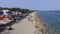 Cheap seaside tenement resort housing along the beach swarmed by low-income local tourists.