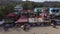 Cheap seaside tenement resort housing along the beach swarmed by low-income local tourists.