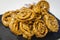 Chebakia moroccan pastries on a slate plate on a handmade tablecloth.