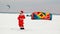 CHEBOKSARY, RUSSIA - DECEMBER 31, 2018: Snowkiting athlete, in the winter in a suit of Santa Clauss, lifts the parachute