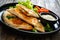 Cheburek - deep-fried turnovers filled with ground meat and vegetables on wooden table