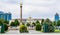 Chechen Republic. Monument `Grozny - a city of military glory` on the Abubakar Kadyrov Square and  city mayor`s office with portra