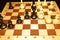 Chechered board and black chessmen like a game theme