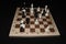 Chechered board with white pawns as a strategy theme