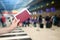 Check-in at the airport terminal, hand with passport and boarding pass on the background of the airport