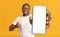 Check This App. Smiling Black Man Demonstrating Smartphone With Blank Screen