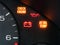 Check engine and other warning signage on car dashboard