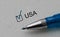 check mark on the word usa and blue pen. Closeup, concept
