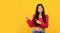 Check this offer. Happy armenian woman pointing fingers at free space over yellow background, panorama