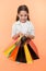 Check out her shopping packages. Child cute shopaholic with bunch shopping bags black friday total sale. Take shopping