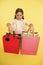 Check out her shopping packages. Girl carries shopping bags yellow background. Girl fond of shopping. Child cute