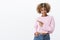 Check it out with me. Joyful and stylish confident attractive woman with blond afro hairstyle in winter warm sweater