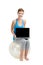 Check out this website for the best workout. a young woman holding a laptop while sitting on a exercise ball.