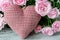 Checked handmade heart against of red and pink roses