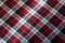 Checked plaid fabric in red, black and white from above