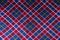 Checked plaid fabric in red, blue and white from above