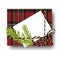 Checked tartan plaid gift present box with tied string bow and a fir tree branch and blank note with copy space. Wrapping diy idea