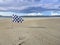 Checked white and flag racing flag on Narin strand by Portnoo, County Donegal, Ireland