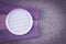 Checked white plate and purple tablecloth