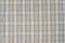 checkered beige fabric lies flat showing pattern and texture